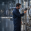 process engineer checking gauges and temperature at a stainless steel vessel sight glass containing amber liquid